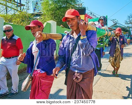 Kyaiktiyo, Myanmar - February 16, 2018: The Porters Carry Elderly Pilgrim On Stretchers To The Kyite
