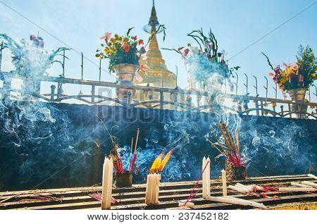 Thick Smoke Of Incense Sticks And Candles, Burning On The Altar Of Kyaiktiyo Pagoda On The Same Name