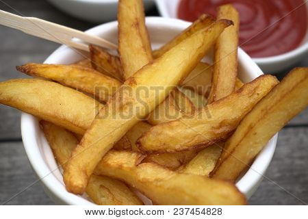 Tasty Food, Nutrition, Kitchen And Culinary Concept: Homemade Fries In Bowl For Snacks On Wooden Bac