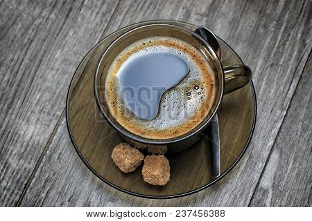 Cup Of Coffee With Brown Sugar On Wooden Table.