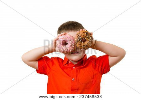 Blond Preschooler Baby Boy With Two Turquoise Donuts On His Eyes On White Background Wall. Child Is 