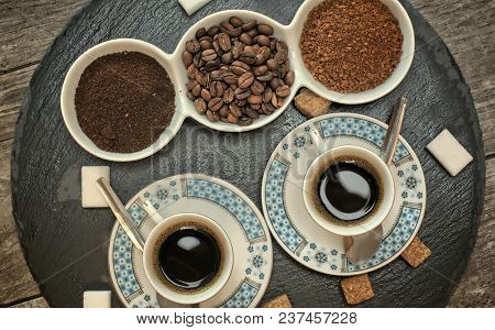 Drinks, Drinking, Energy And Caffeine Concept-two Cups Of Coffee, Coffee Beans, Ground Coffee And In