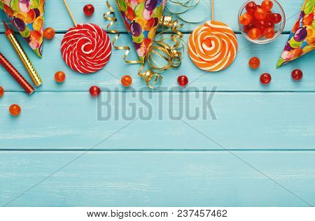 Party Border Of Colorful Candies And Gifts, Top View. Holiday Decorations, Lollipops And Confetti On