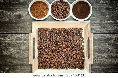 Caffeine Design Concept-ground Coffee, Instant Coffee And Coffee Beans On A Wooden Background.