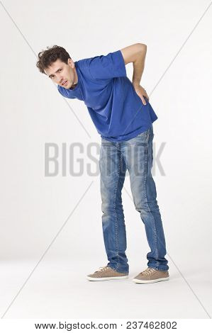 Boy In Blue T-shirt And Jeans Having Hurt The Back