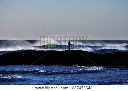 Photographer Photographing The Waves At El Palmar On The Rocks,cádiz,spain.