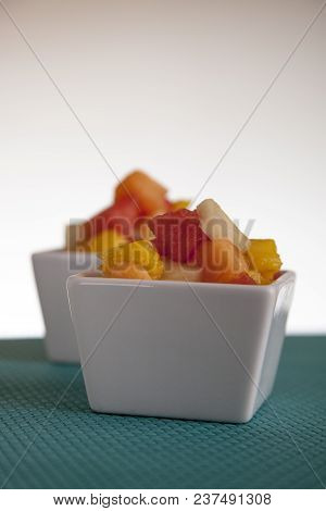 Fruit Salad Mix Of Melon, Banana, Watermelon, Orange And Pineapple In A Small Porcelain Bowl, Breakf