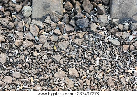 Ground Polluted With Cigarette Butts And Other Garbage. Dirty Street Full Of Rubish And Litter. Low 