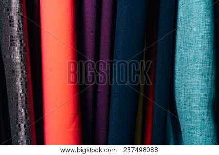 Different Types Of Fabrics Are Folded Neatly In A Row