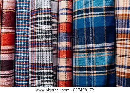 Different Types Of Fabrics Are Folded Neatly In A Row