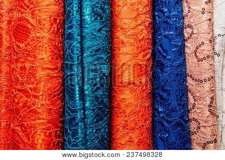 Different Types Of Fabrics Are Folded Neatly In A Row