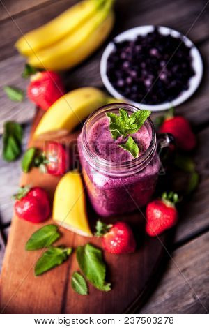Blueberry Smoothies On A Wooden Background With Fruits. Vitamins A