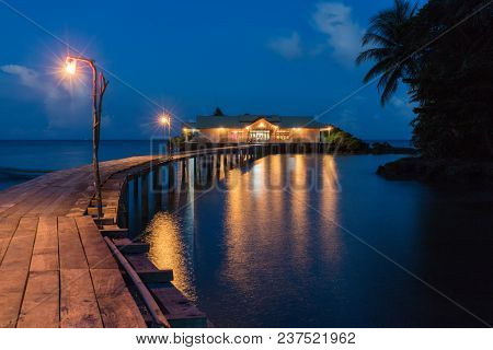 Wooden warf leading to a floating house, Hatta island, Maluku, Indonesia