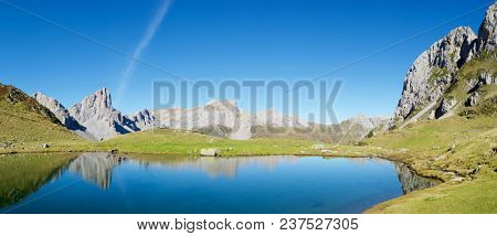Peaks reflected in Ansabere Lake. Lescun Cirque. Aspe Valley, Pyrenees, France.