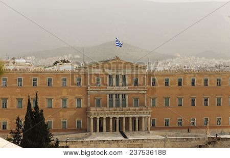 Greece, Athens pollution. UGrey smog over parliament at Syntagma. Sky, hill and town background.