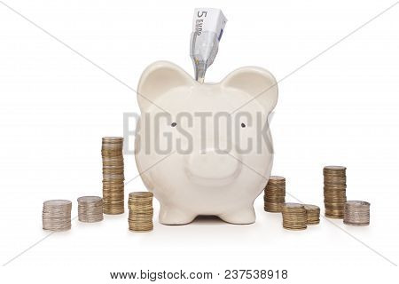 The Piggybank With Five Euro Bill And Coins Stack On White Background