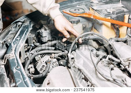 Auto Mechanic Repairing Car. Selective Focus, Dirty Hands