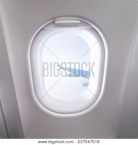 Airplane Window View Inside An Aircraft. Window Plane. Vacation Destinations Concept. Clouds And Sky