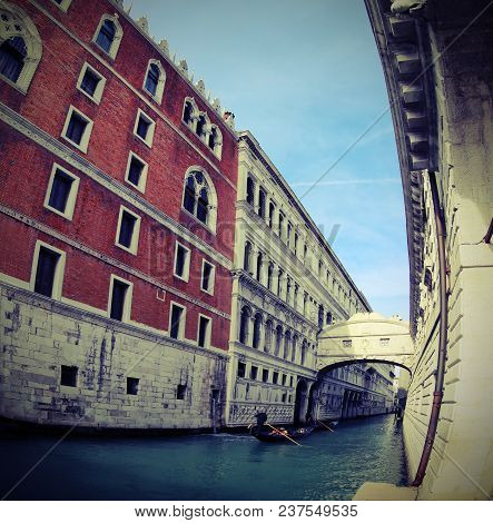 Ancient Bridge Of Sighs And Old Ducal Palace Photographed By Fish Eye Lens And A Gondola Boat In Ven