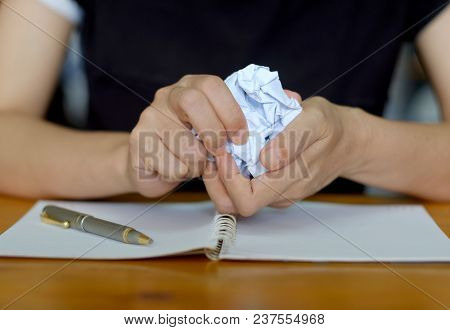 Hands Crumpling Paper After Mistake During Writing On Working Desk In The Office.
