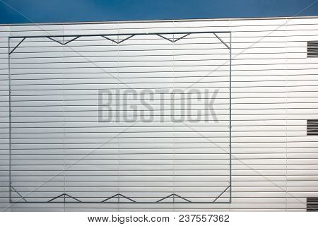Empty Blank Steel Billboard Frame On Facade Of Industial Style Building