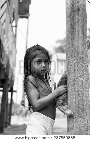 Boca De Valeria, Brazil - December 03, 2015: Child Girl Selling Sloth In Village. Earning Money And 