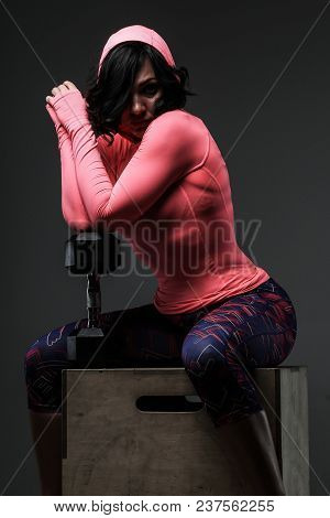 Attractive Fitness Woman In Sportswear Posing With Dumbells In Sudio On Grey Background