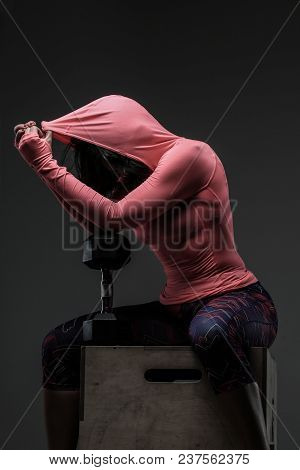 Attractive Fitness Woman In Sportswear Posing With Dumbells In Sudio On Grey Background