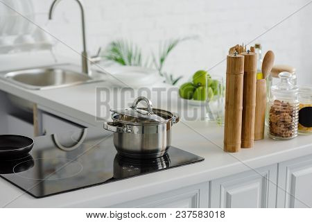Pan On Electric Stove, Ripe Delicious Apples At Kitchen Counter