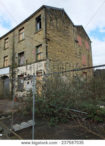 Derelict Abandoned Industrial Mill In Huddersfield England With Boarded Up And Broken Windows