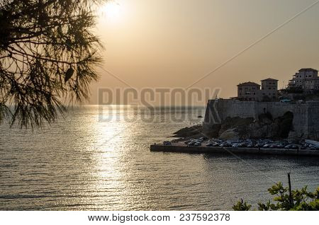 Beautiful Sunset View On Sea And Stadi Grad - Old Town Of Ulcinj At Twilight Scene. Coast Of Adriati