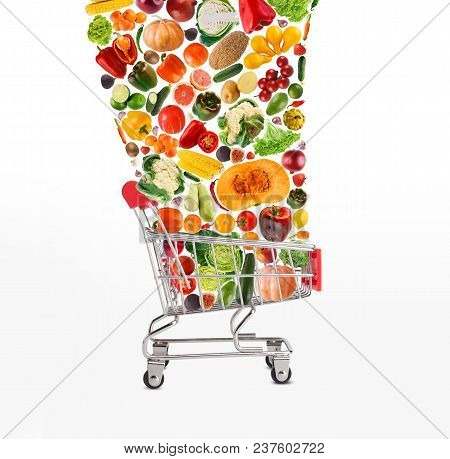 Grocery Cart With Vegetables And Fruits Falling In It Isolated On White. Healthy Meals Shopping, Cor