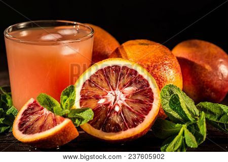 Glass Of Fresh Pulpy Blood Orange Juice On Wooden Rustic Background. Selective Focus. Summer Refresh