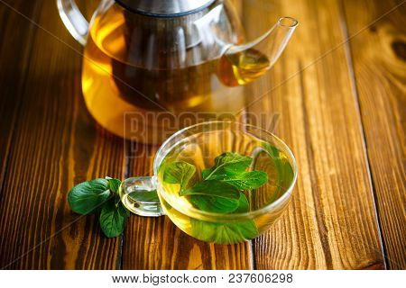 Hot Green Tea With Fresh Mint On A Wooden Table