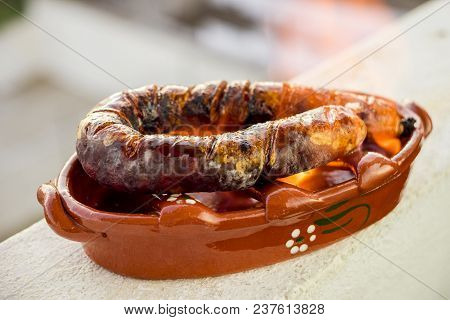 Traditional Portuguese Chourico Or Spanish Chorizo Prepared In A Special Clay Pot