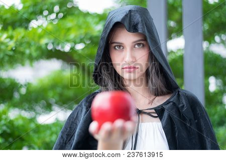 A Young Beautiful Witch With Red Apple.