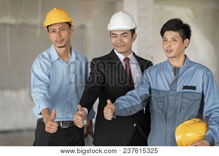 Architect With Business Man And Engineer Are Turn Thumbs Up. Looking At Camera. Smiling. Selecive Fo