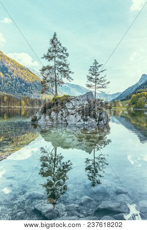 Beautiful Scene Of Trees On A Rock Island In Idyllic Scenery At Charming Lake Hintersee With Blue Sk