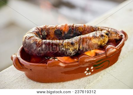Traditional Portuguese Chourico Or Spanish Chorizo Prepared In A Special Clay Pot