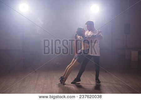 Young Couple Dancing Social Danse Kizomba Or Bachata Or Semba Or Taraxia In Dancing Class Background