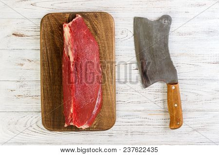 Red Fresh Raw Beef Veal Fillet On Cutting Board. White Wooden Background.