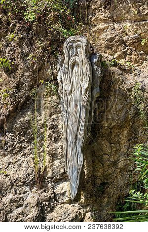 Historical Sculpture Made Of Wood In The Form Of An Old Man. Church And Religion