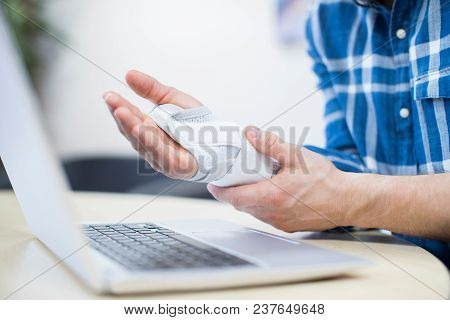 Close Up Of Businessman Using Laptop Suffering From Repetitive Strain Injury (rsi)