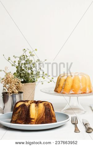 A Vanilla And Chocolate Bundt Cake And A Lemon Bundt Cake