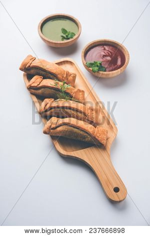 Coriandar Or Sambar Vadi Also Known As Kothimbir Vada In Marathi. Served With Green Chutney And Toma