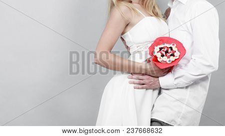 Closeup Of Couple With Candy Bunch Flowers. Love.