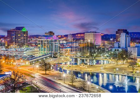 Huntsville, Alabama, USA park and downtown cityscape at twilight.