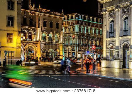 Lisbon, Portugal - April  15, 2018 . People In Front Of The Neo-manueline Style Facade Of Rossio Rai