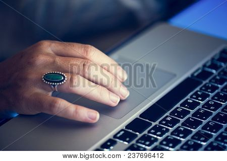 Hand working typing on laptop