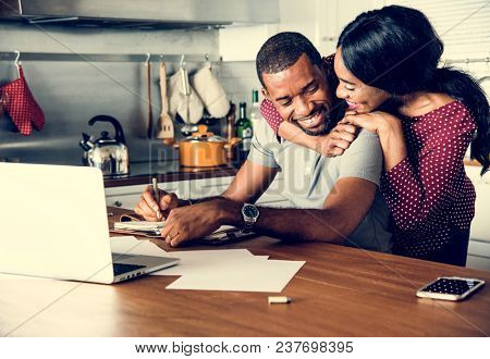 Black couple hugging together